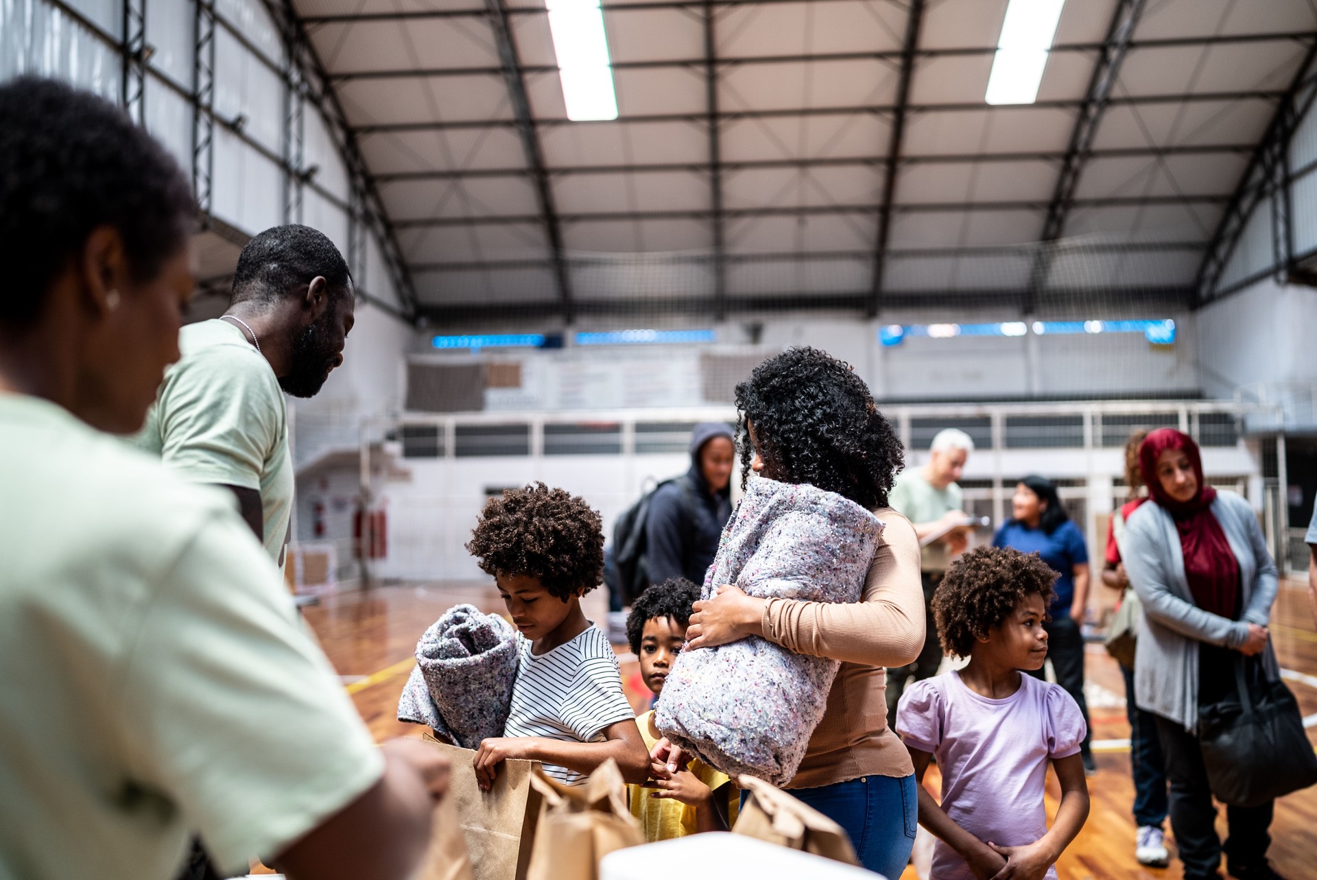 Refugee family getting a donation in a sheltering